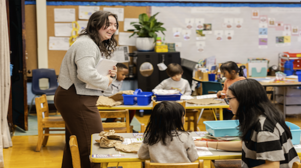 A woman in a classroom teaching kids A woman in a classroom teaching kids